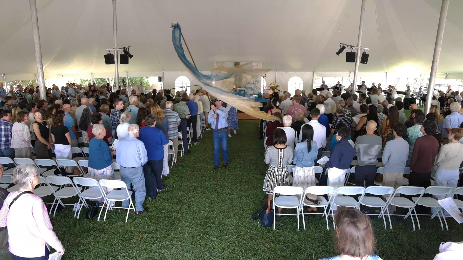 Audience at a live event under a tent